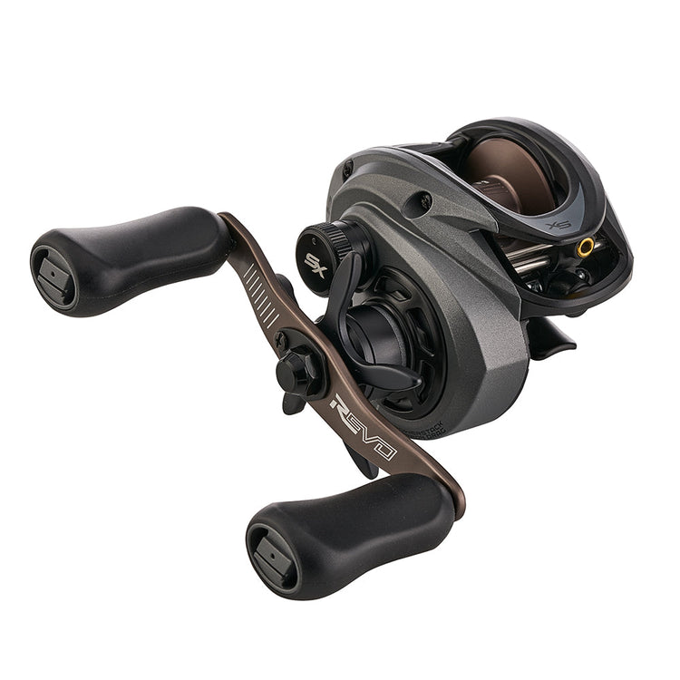 Close-up of a black and gray baitcasting fishing reel with two ergonomic handles. The reel features sleek design elements and labeled "Revo" on the frame.