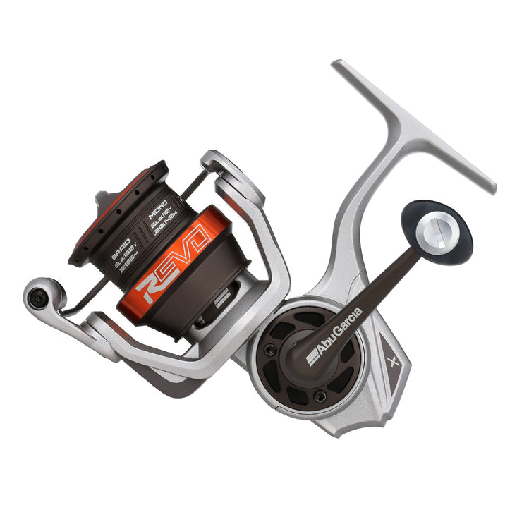 A silver and black fishing reel with an orange accent is shown against a white background. The reel is labeled "Abu Garcia" and features a modern, sleek design with a handle on the right side.