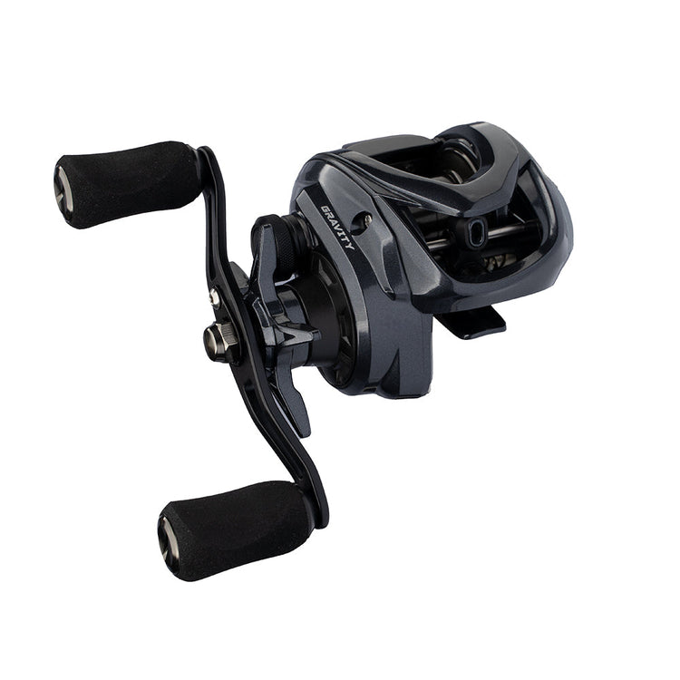 A close-up of a black baitcasting fishing reel with dual handles featuring foam grips. The reel has a sleek design with metallic accents and visible internal mechanisms.