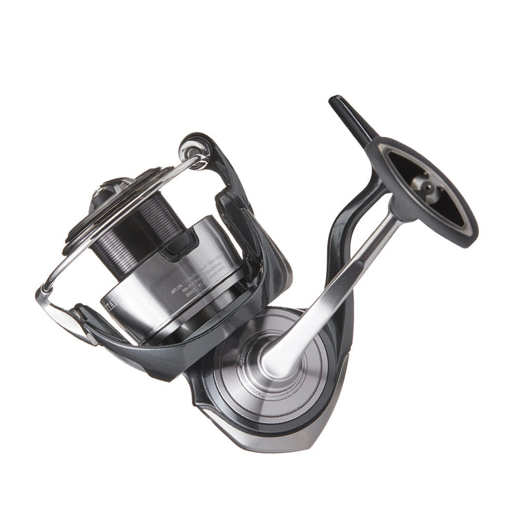 A silver and black fishing reel with a sleek design. The reel features a handle on the right side and a spool on the left, designed for efficient line retrieval.