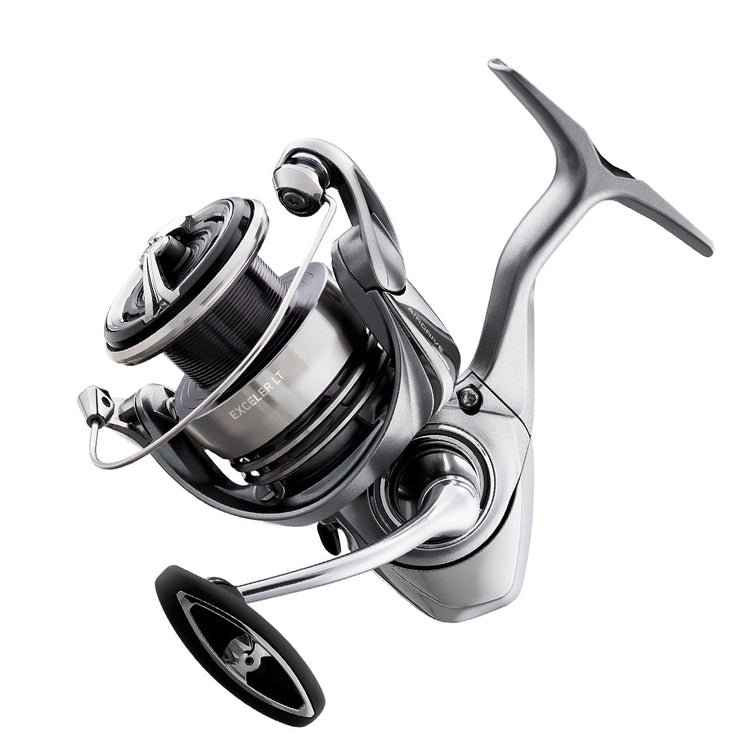 A close-up of a metallic spinning fishing reel with a modern design, featuring a smooth silver finish, a visible line spool, and a crank handle on the right side.