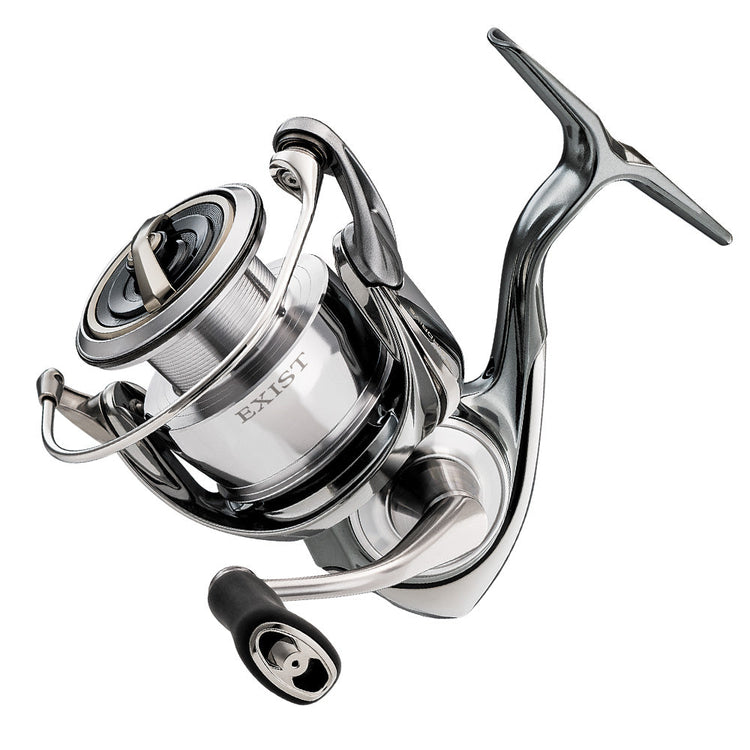 Close-up of a modern silver and black fishing reel with the word "EXIST" printed on it. The reel features a sleek, metallic design with several moving parts, including a handle and spool.