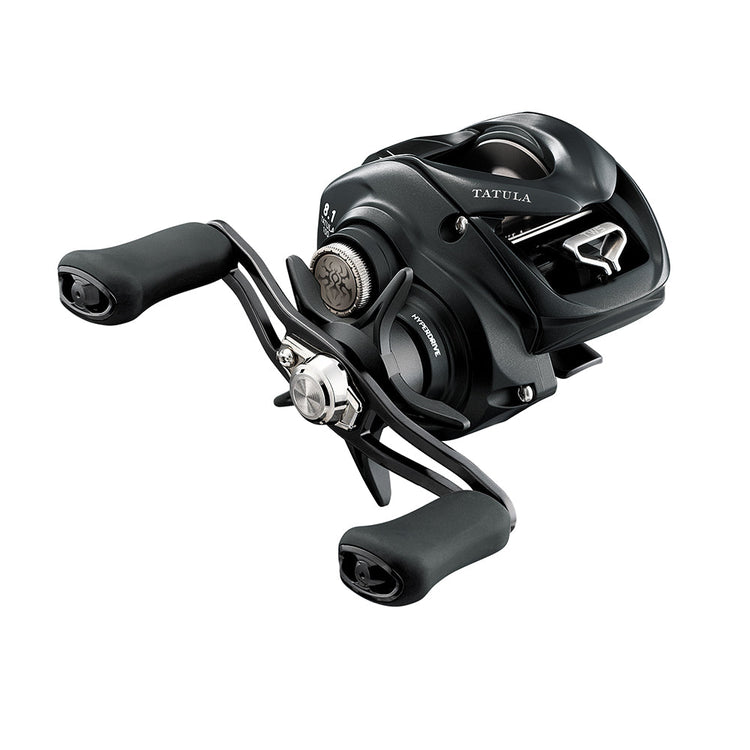 A sleek black fishing reel with dual handles and ergonomic grips, featuring the brand name "Tatula" and a metallic spool. It's designed for baitcasting, with a modern and sturdy appearance.