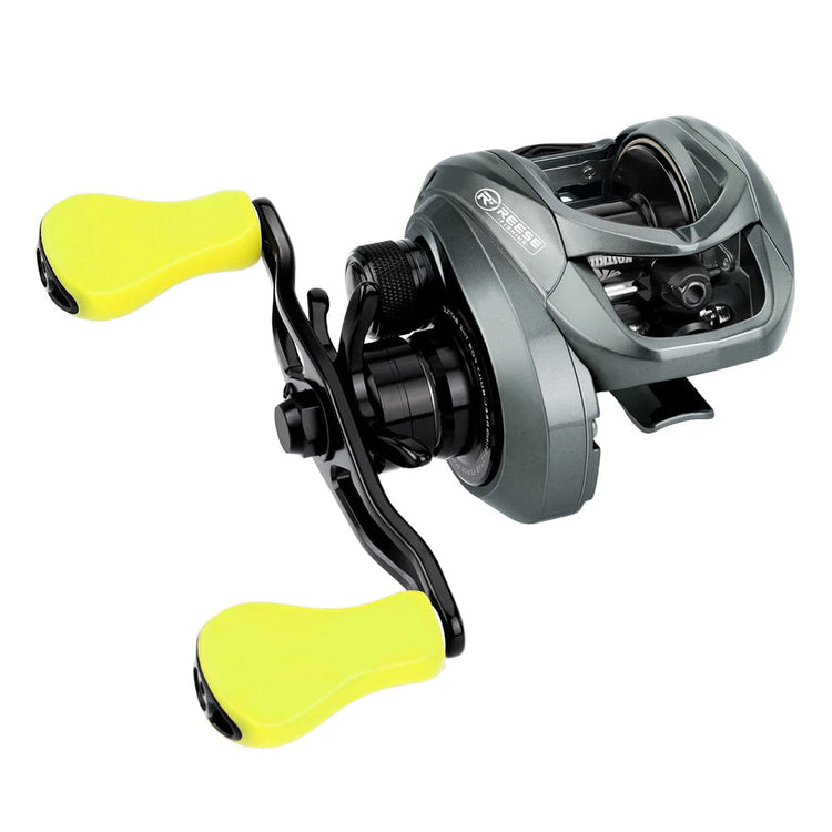 A close-up of a gray baitcasting fishing reel with two bright yellow handles. The reel features a compact design and visible internal components.