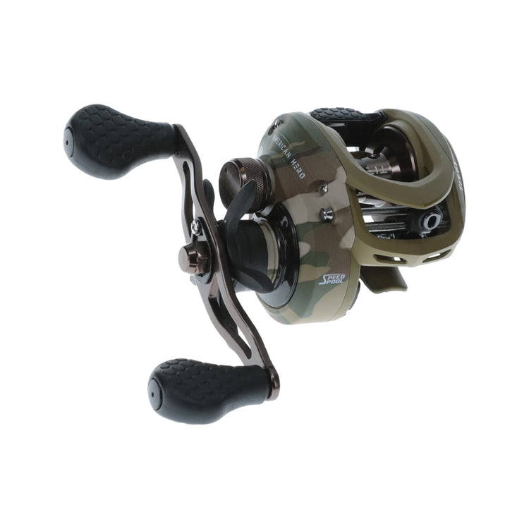 A camouflage-patterned baitcasting fishing reel with two textured black handles and a metal crank, positioned against a plain white background.