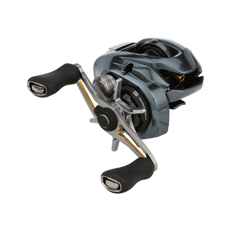 A close-up of a modern fishing reel with sleek metallic design and dual black handles. The reel features intricate details, highlighting its advanced mechanics and precision engineering.