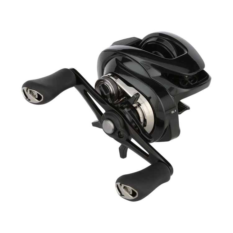 A black and silver fishing reel with ergonomic handles and a sleek design is shown against a white background.