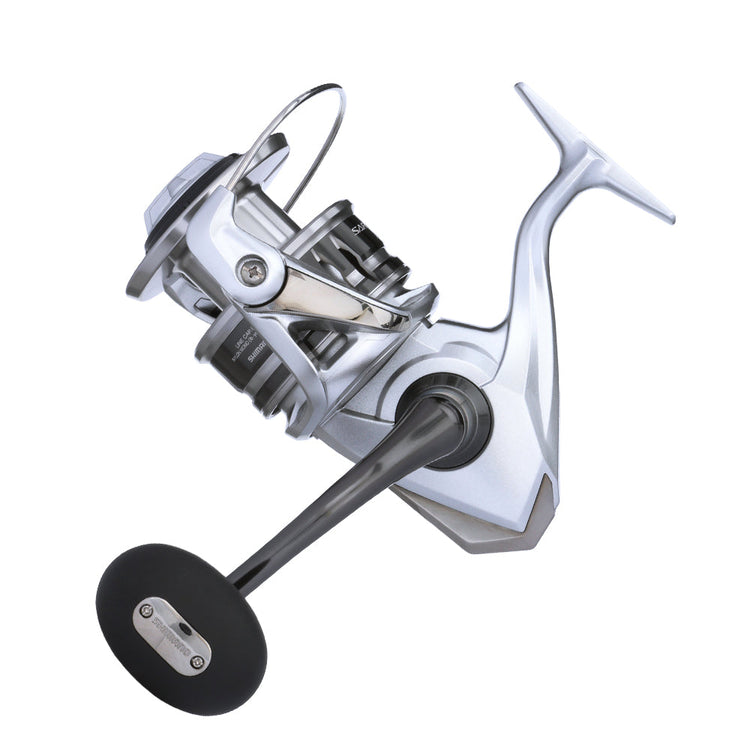 A modern silver fishing reel with a sleek design, showing a black handle and intricate metal components against a white background.