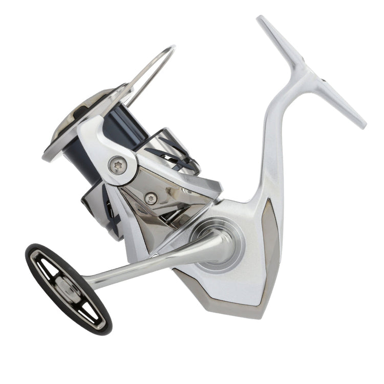 A modern spinning fishing reel with a sleek design, featuring a silver metallic finish and a black handle, is positioned on a white background.