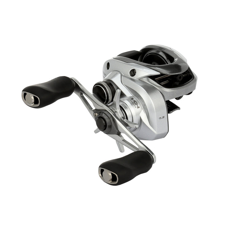 A silver fishing reel with two black handles is positioned against a white background. The reel features a sleek design with visible components and intricate details.