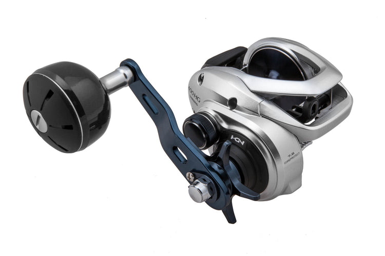 Silver and black fishing reel with a large handle and metallic components. The design is sleek and modern, featuring a prominent gear and spool mechanism.