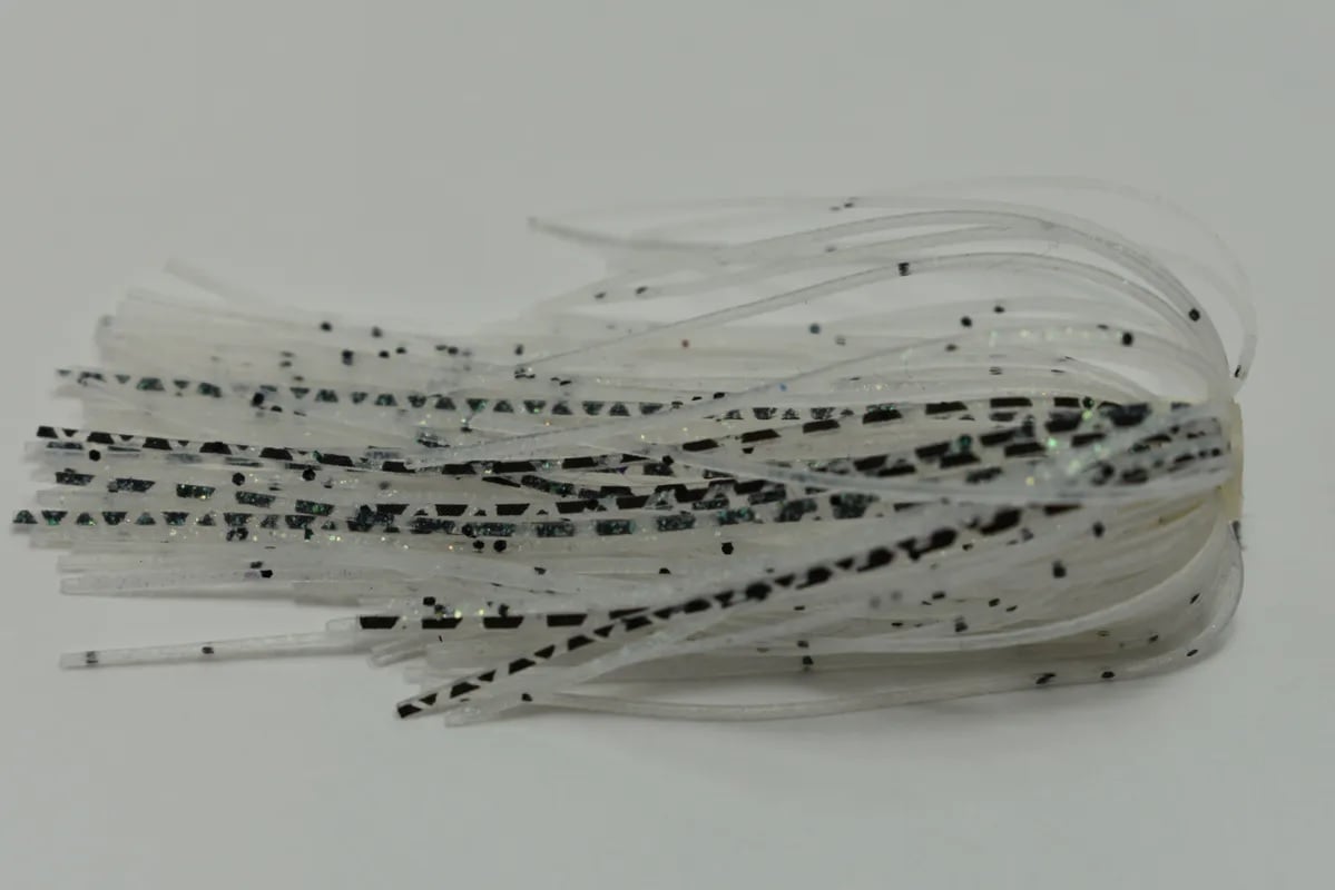 Close-up of white and black speckled silicone strands from the Accent River Special Spinnerbaits by Accent, elegantly layered like a tassel, reminiscent of expertly crafted spinnerbaits seen at the Bassmaster Classic, set against a plain background.