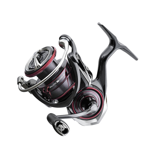 A detailed view of the Daiwa Ballistic MQ LT Spinning Reel 3000D 5.2:1 | BLSMQLT3000D reveals its sleek black and red design. Featuring a curved handle and exposed metal components, the reel's intricate construction is highlighted. The use of Zaion-V material enhances its durability, with the Daiwa brand partially visible on the side.