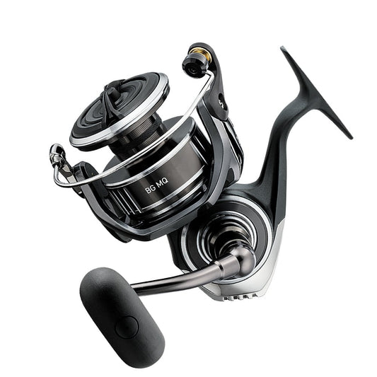 The Daiwa BG MQ 18000 5.3:1 Spinning Reel, ideal for saltwater fishing, is shown in a close-up highlighting its sleek black and silver design with a prominent handle and sturdy spool against a white backdrop.