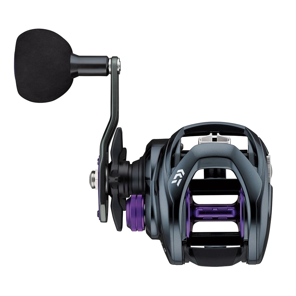 Close-up of the Daiwa Prorex TW Casting Reel Left Hand 5.3:1, displaying a sleek black and purple design with a large padded grip handle. The metallic frame has intricate details, making it ideal for musky fishing enthusiasts.