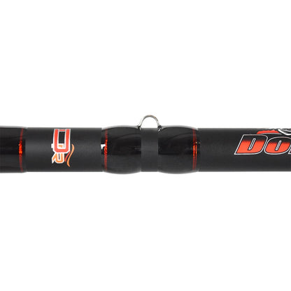 Close-up of a Dobyns Kaden Casting Rod KD 744C with full cork handles. The black rod features red accents, a metal loop connecting sections, and labels in orange and white. High modulus blanks guarantee seamless joining of the rod's 7'4" heavy sections.