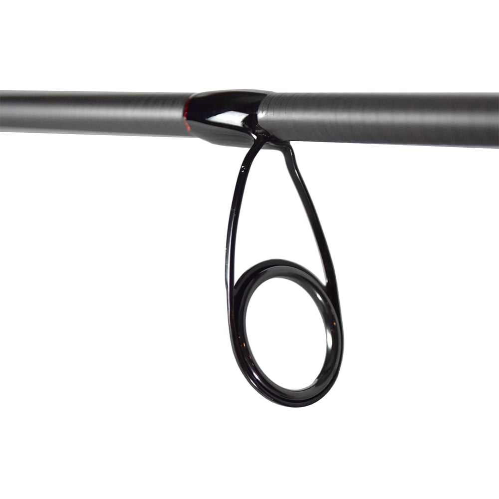 Close-up of a Dobyns Kaden Spinning Rod guide from americanlegacyfishing, featuring a sleek metal ring on the dark gray KD 712SF rod. Red accents enhance its design, with an out-of-focus white background complementing the elegant look.