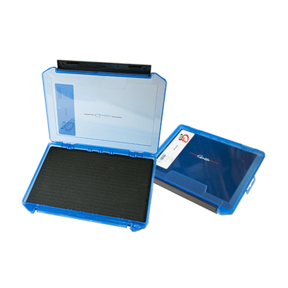 Two blue rectangular storage cases are shown: one is closed, and the other is the Gamakatsu G-Box 3600 Slit Foam Case with a black foam interior. Both have clear tops with red and black markings, and one has a barcode tag attached.