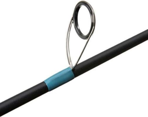 A close-up of the G. Loomis NRX+ Jig & Worm Spinning Rod 852S JWR 7'1" Medium by americanlegacyfishing shows a metal loop eyelet with a blue band on a black rod, featuring Spiral X technology for guiding line during casting and retrieval.