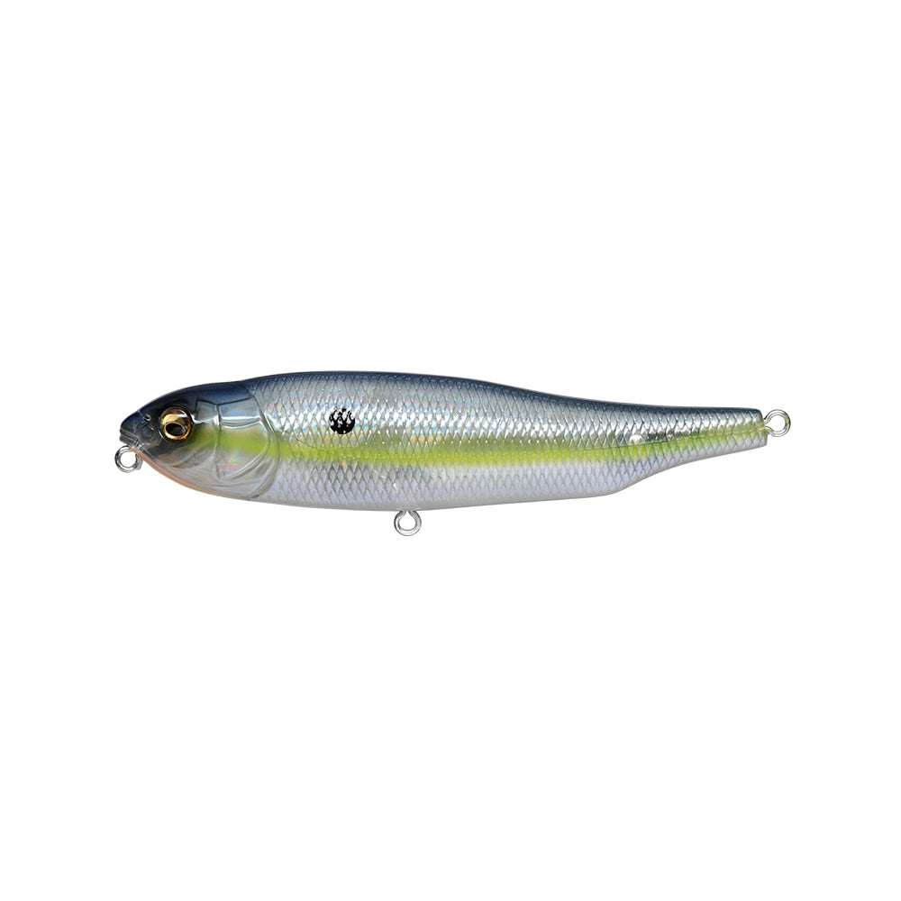 The Megabass Giant Dog-X lure resembles a fish in silver and green, with a textured body, small eye, and two line loops. It offers roll-walking action thanks to its reflective surface and features a lateral tungsten balancer.