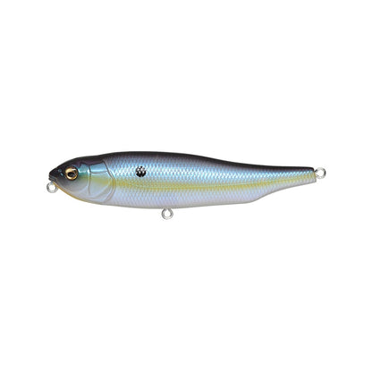 The Megabass Giant Dog-X is a realistic metallic fishing lure by Megabass, designed to resemble a small fish with textured scales, glossy silver-blue body, lifelike eye, and two eyelet hooks. It includes a black spot near the head and features an innovative lateral tungsten balancer for optimal roll-walking action.