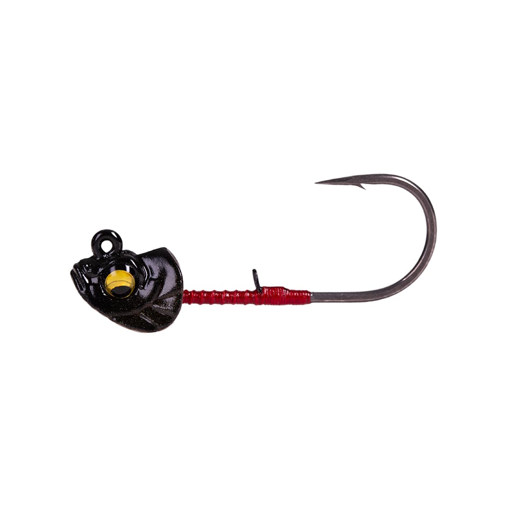 The Megabass Okashira Head fishing jig by Megabass boasts a hydrodynamic design with a sharp, upward-curving hook. Its shiny black, fish-shaped head features a prominent yellow eye, while the red body is ideal for securing finesse swimbaits.