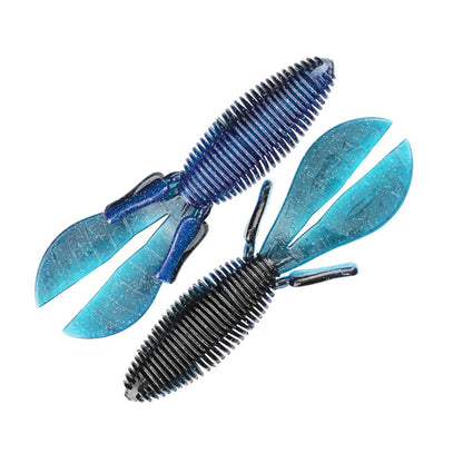 Two Missile Baits D Bomb lures from Missile Baits are blue and made of ribbed plastic, featuring large split tails ideal for pitching and flipping as lifelike creature baits. These lures have textured bodies with glittery finishes to enhance their attraction in the water.