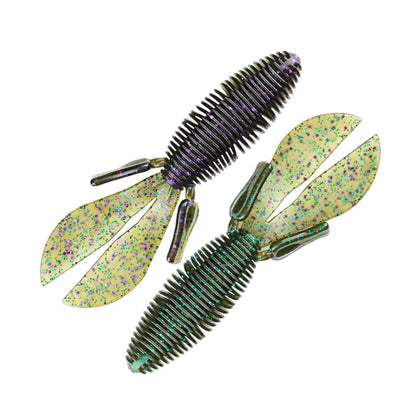 Two Missile Baits D Bomb creature baits feature ribbed bodies and paddle tails. One lure comes in a dark color with purple accents, while the other is a light yellow shade decorated with multicolored speckles.