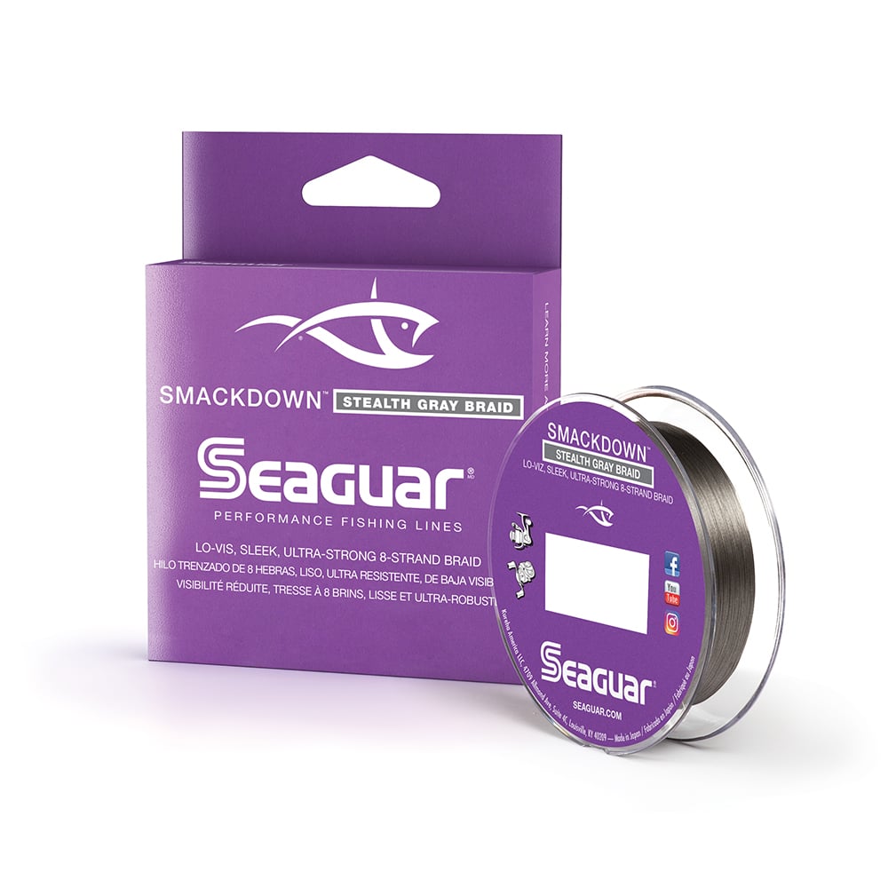 A Seaguar Smackdown Braided Line 150yd package with a spool beside it. The purple packaging prominently displays "Lo-Vis Smackdown Stealth Gray," emphasizing its performance as a low-visibility, ultra-strong, braided line with an 8-strand design for superior stealth and strength.