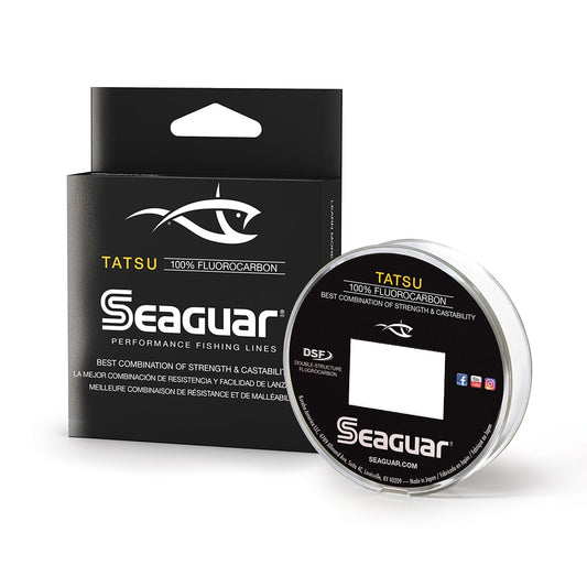 The Seaguar Tatsu Fluorocarbon Line packaging flaunts a stylish black and white design accented with gold text. It showcases the Seaguar logo and highlights its innovative double-structure process, emphasizing exceptional strength and castability.