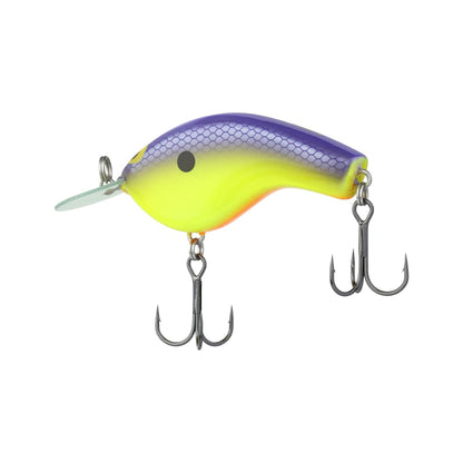 The Shimano Macbeth Flat Crankbait, designed by Shimano, is a vibrant fishing lure featuring a curved design. It boasts a purple top, yellow center, and orange base. At the front, it includes a Circuit Board Round Bill and is equipped with two treble hooks underneath.