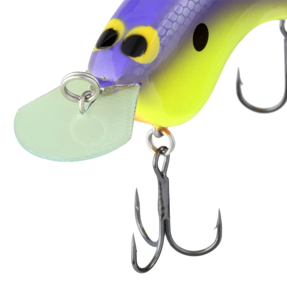 Close-up of a colorful Shimano Macbeth Flat Crankbait, featuring a purple and yellow body with large eyes. It boasts a shiny metal loop, translucent lip at the front, and two sharp treble hooks at the bottom.