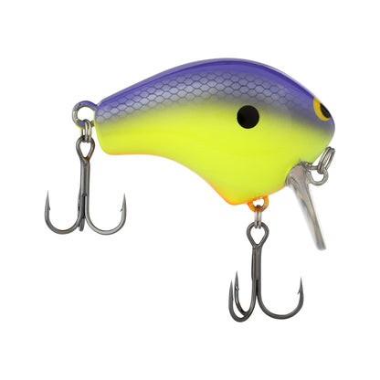 The Shimano Macbeth Shallow 50F Wake Bait by Shimano is a brightly colored fishing lure that transitions from purple to yellow, accented with a small black dot near the top. Resembling a fish, it includes two treble hooks: one on the underside and another at the back, making it ideal for attracting catches in shallow waters.