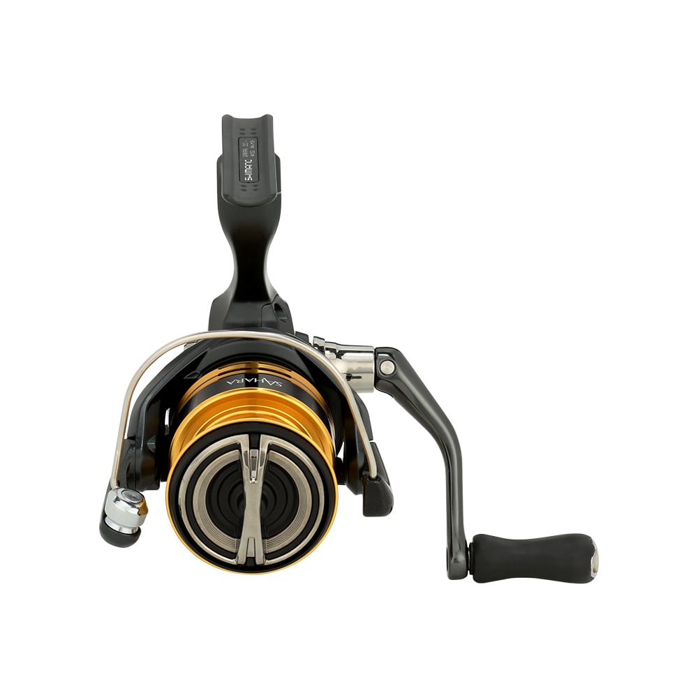 A close-up of an americanlegacyfishing Shimano Sahara FJ Spinning Reel 2500FJ (model SH2500FJ) reveals its meticulously crafted black handle and gold spool. Positioned upright, the reel showcases visible HAGANE Gear components, emphasizing its innovative design against a white background.