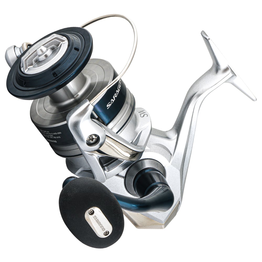 The Shimano Saragosa Spinning Reel 18000SWAHG from americanlegacyfishing, in a sleek silver and blue design with a black handle, highlights its state-of-the-art Infinity Drive Technology on a smooth surface against a white background.