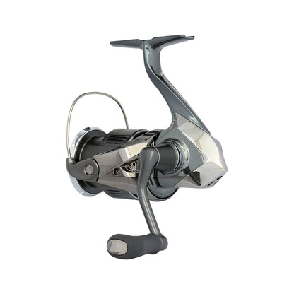 The Shimano Stella FK Spinning Reel 2500HGFK, also known as STL2500HGFK, from americanlegacyfishing, showcases a contemporary metallic design with a polished crank handle and gleaming components. Set against a plain white background, this reel emphasizes its intricate details and state-of-the-art Shimano technology.