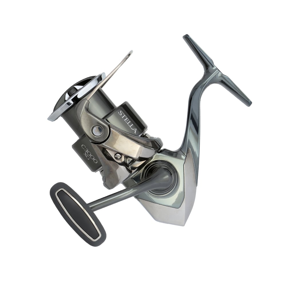 This stylish silver and black Shimano Stella FK Spinning Reel 4000XGFK (STL4000XGFK) from americanlegacyfishing features a one-sided handle, opposing spool, InfinityDrive technology, and is showcased against a white backdrop.