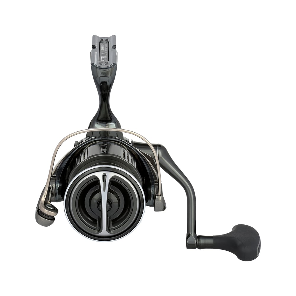 Close-up of a Shimano Stella FK Spinning Reel 4000XGFK by americanlegacyfishing in black and silver with a right handle. The reel features a metallic spool and InfinityDrive mechanism, highlighting intricate mechanical details for top performance.