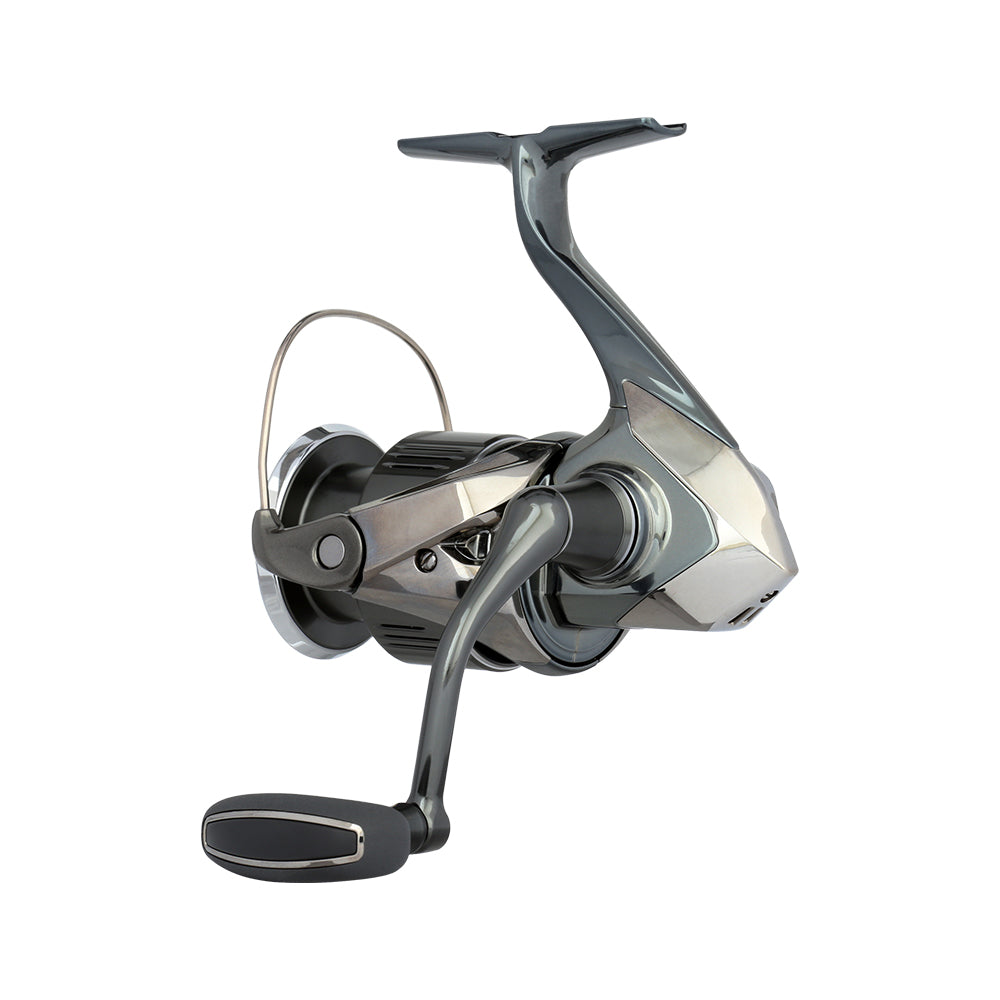 A close-up of the Shimano Stella FK Spinning Reel 4000XGFK from americanlegacyfishing reveals a sleek, metallic design with a dark, glossy finish. It features InfinityDrive technology, a comfortable handle, and a streamlined body for optimal efficiency during fishing adventures.