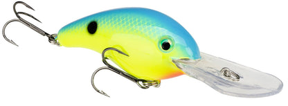 The Strike King 5XD Crankbaits, featuring a blue top, yellow body, and black dot near the head, boasts a clear plastic lip with a curved bill for deep diving. Equipped with treble hooks at the bottom and rear, it resembles other colorful lures in its design.