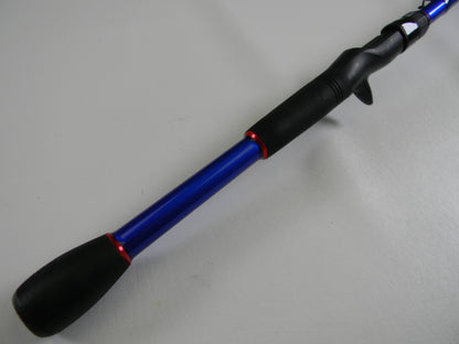 A close-up of the Duckett Wheeler Series DFJW72MH-CC casting rod showcases its blue handle, black grip with red accents, and reel seat. This 7'2" medium-heavy cranking rod is in excellent used condition against a gray background, ideal for earning store credit in the Rod and Reel Trade-In Program.