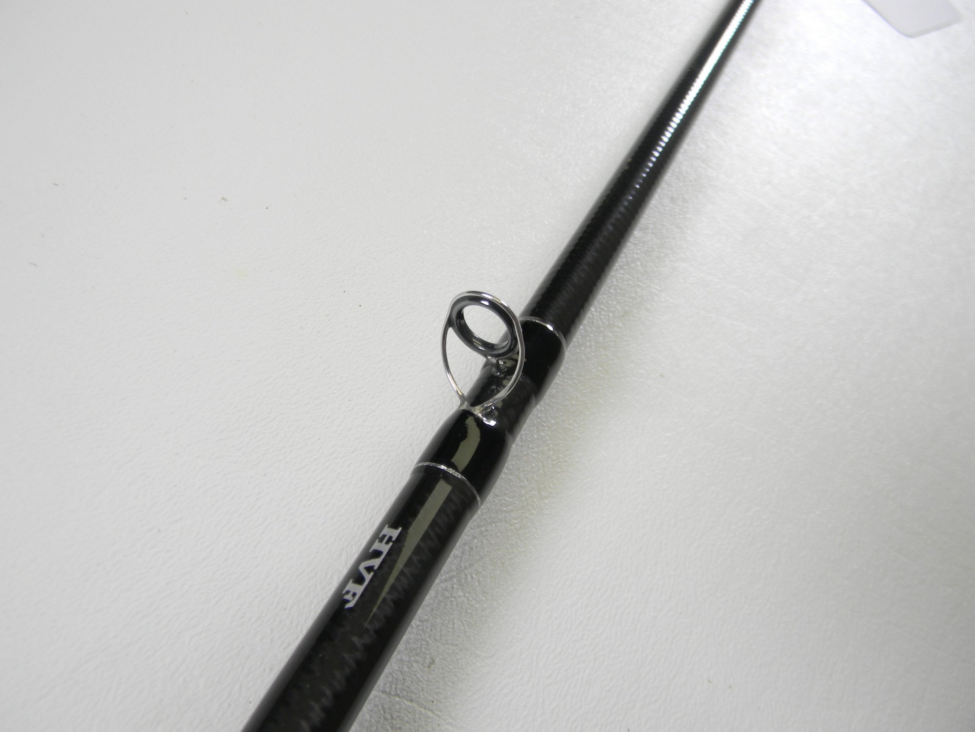 A close-up of a Daiwa BLX BLXLG731MLFB 7'3" Medium Light used casting rod in excellent condition. The sleek black design with a visible guide ring is showcased against a plain white background—ideal for our Rod and Reel Trade-In Program to earn store credit for your next adventure.