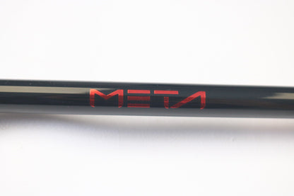 A close-up of a black 13 Fishing Meta MTGC74MH 7'4" Medium Heavy used casting rod with "META" in red, centered on a white background. Ideal for our Rod and Reel Trade-In program or for obtaining store credit on pre-owned gear.