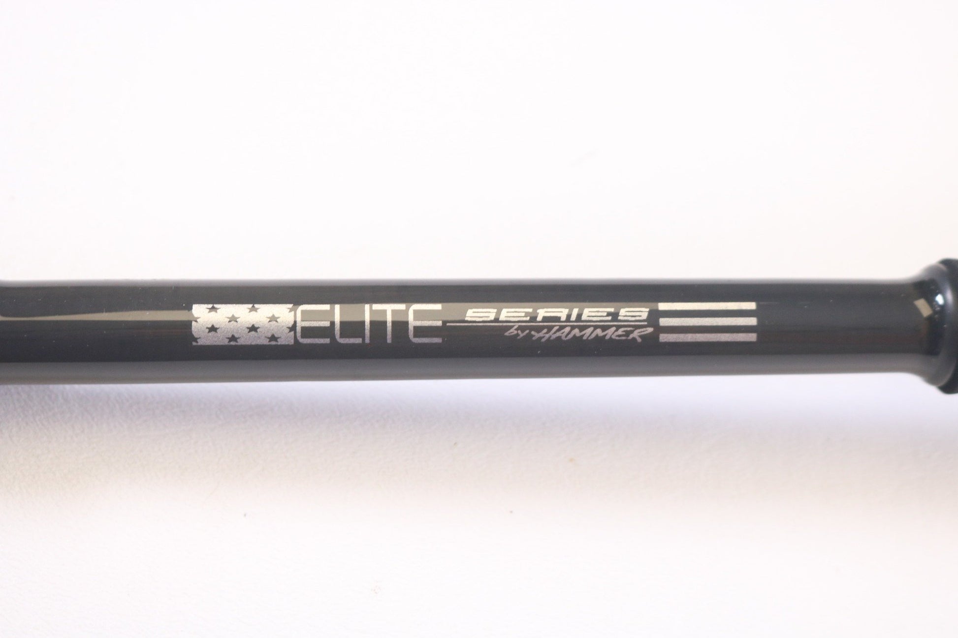 A close-up of a black Hammer rod, featuring "Elite Series by Hammer" and a stylized American flag. Ideal for our Rod and Reel Trade-In Program to earn store credit while upgrading your used gear. The background is crisp white.