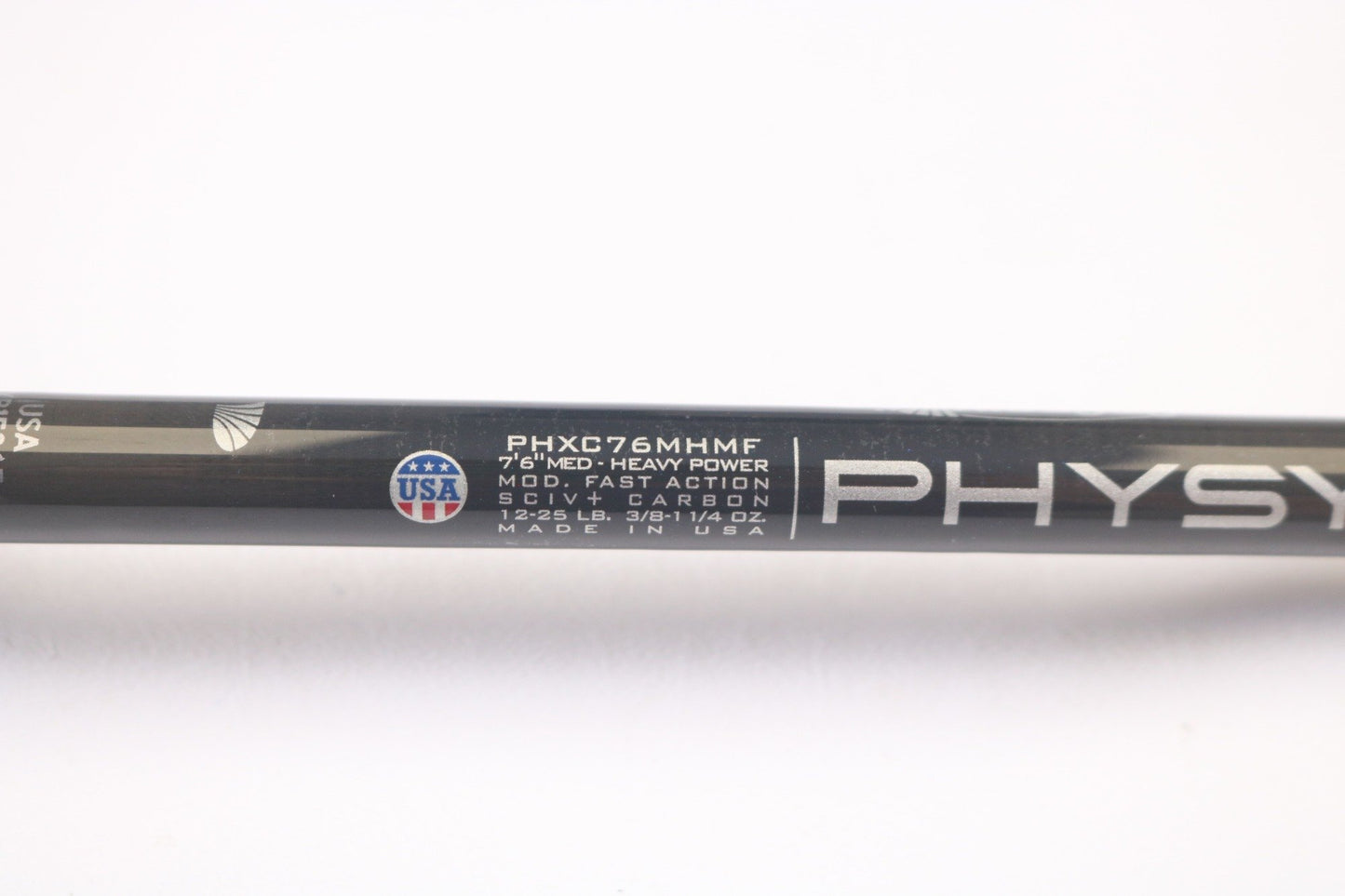 Close-up of a St. Croix Physyx PHXC76MHMF 7'6" Medium Heavy casting rod in mint condition, showing specifications and "Made in USA" with a small flag emblem. The words "PHYS" are partially visible, ideal for our Rod and Reel Trade-In Program to earn store credit on used gear.