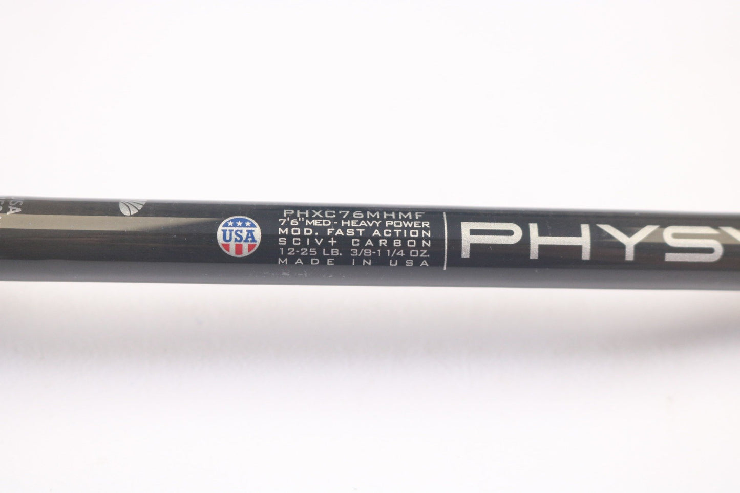 Close-up of a sleek black St. Croix Physyx PHXC76MHMF casting rod, part of our Rod and Reel Trade-In Program. Specs: 7'6" medium heavy power, mod fast action, SC VI carbon, 12-25 lb line, 3/8-1 1/4 oz lure. Proudly made in the USA. Perfect for boosting your fishing game! Mint condition!.