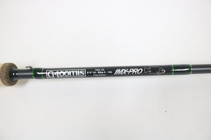 Get a close-up of the G. Loomis IMX-Pro 722C CR Used Casting Rod in mint condition, 6'0", 1/4-5/16 oz, 1-8 lb, Fast Action. This sleek black rod with green accents is ready for your next adventure. Upgrade with our Rod and Reel Trade-In program for store credit.