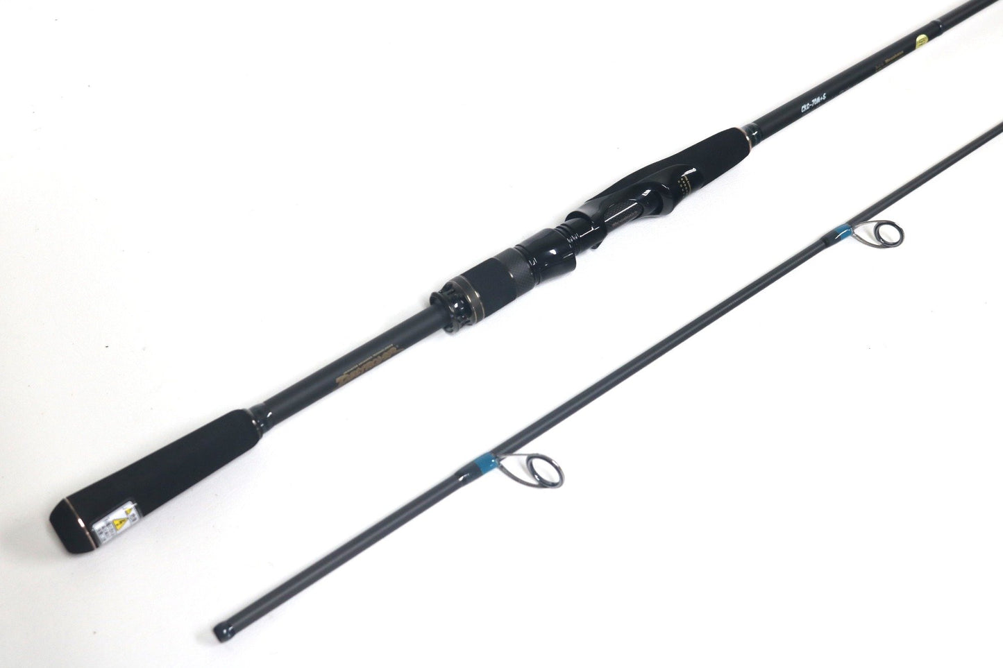 The Megabass Cookai Gulf Inshore Spinning Rod - CKG72MS, available for Rod and Reel Trade-In, comes in black and is disassembled into two pieces with a sleek reel seat, multiple line guides, a comfortable grip, and a glossy finish. Shown against a white background, it's ideal for quality used gear seekers.