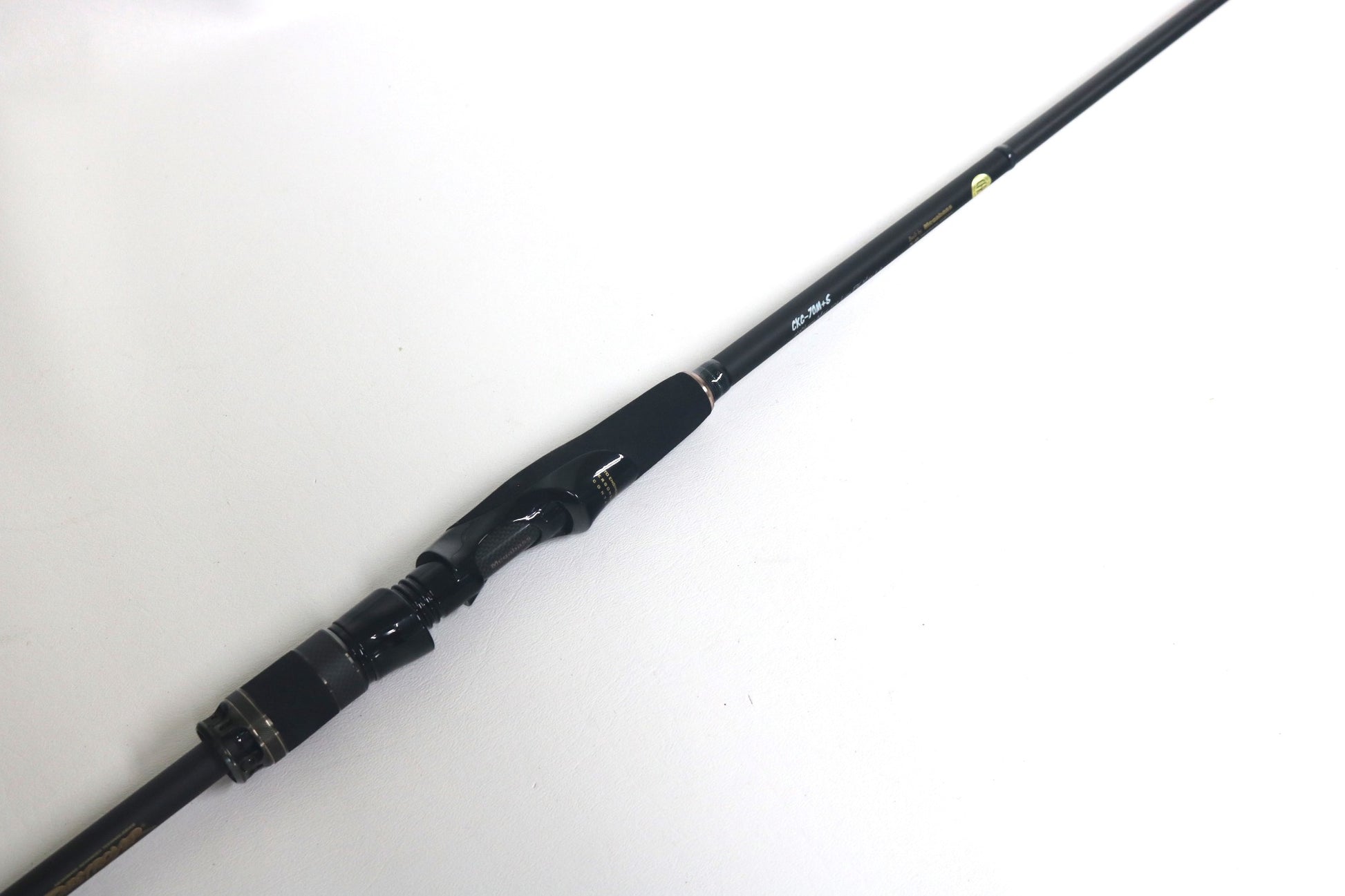 The Megabass Cookai Gulf Inshore Spinning Rod - CKG72MS, in excellent used condition, is displayed diagonally on a white background, highlighting the handle and reel seat. Ideal for those eyeing a Rod and Reel Trade-In or exploring Used Gear to gain Store Credit for your next purchase.