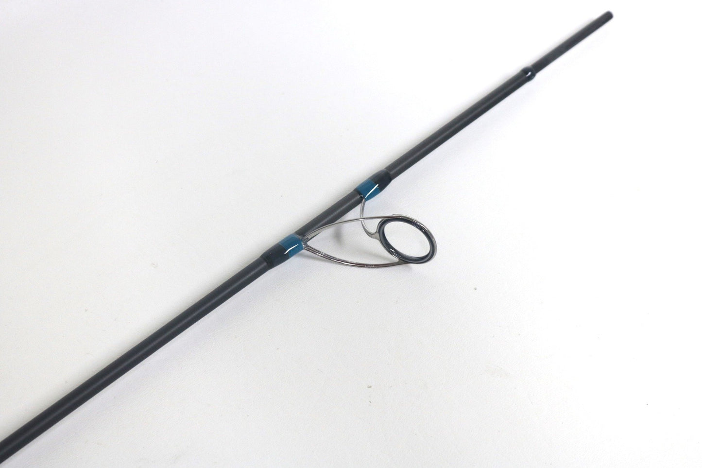 Close-up of the Megabass Cookai Gulf Inshore Spinning Rod tip, featuring a black finish and single guide ring, ideal for those eyeing used gear or maximizing their rod and reel trade-in for store credit.